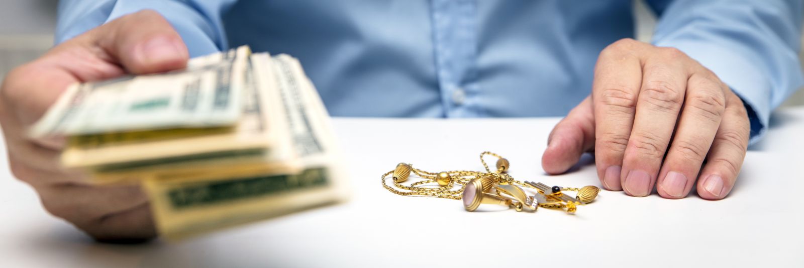 antiques dealer handing over money from buying jewelry